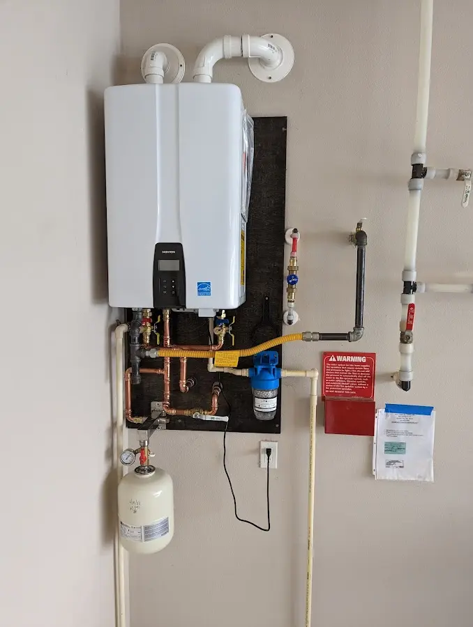 Professional plumber installing copper piping in a Chippewa home